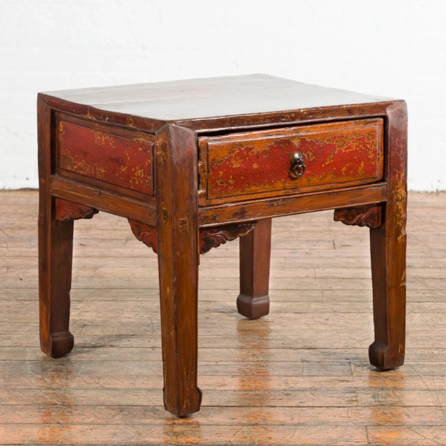 A Chinese Qing Dynasty period side table with single drawer from the 19th century, with horse hoof legs, cinnabar...