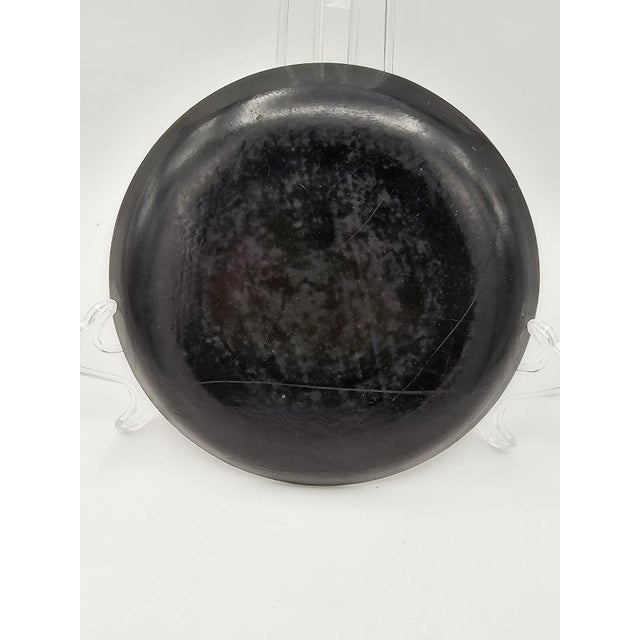 This antique Chinese plate from the 19th century features a beautiful black lacquer ware finish with intricate gilt...