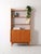 Scandinavian 60s furniture in teak and birch. This piece of furniture with built-in bookcase, created in the full...