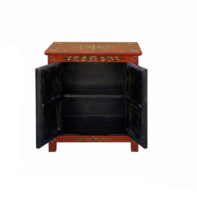 This cabinet/table is painted with a distressed brick red color on the main body and black color Tibetan-style flower &...