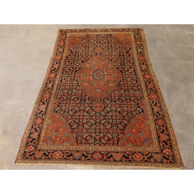 Herati pattern on blue field with floral central medallion and matching spandrels. Blue border with floral decoration....