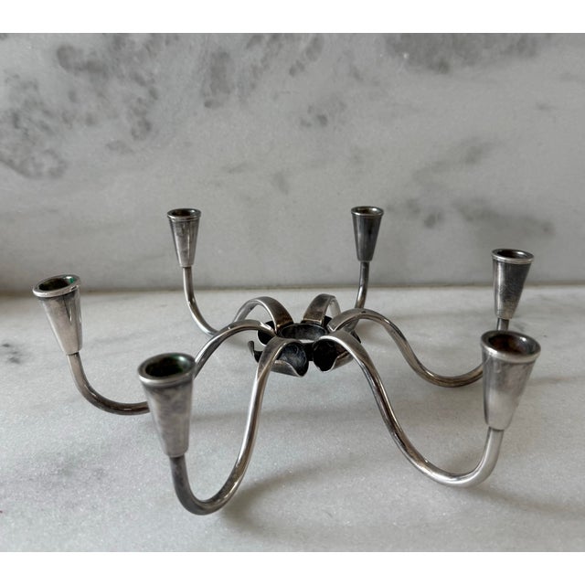 Vintage mid century modern silver plate candelabra with 6 spider like arms and cone fluted candle holders at the end. Made...