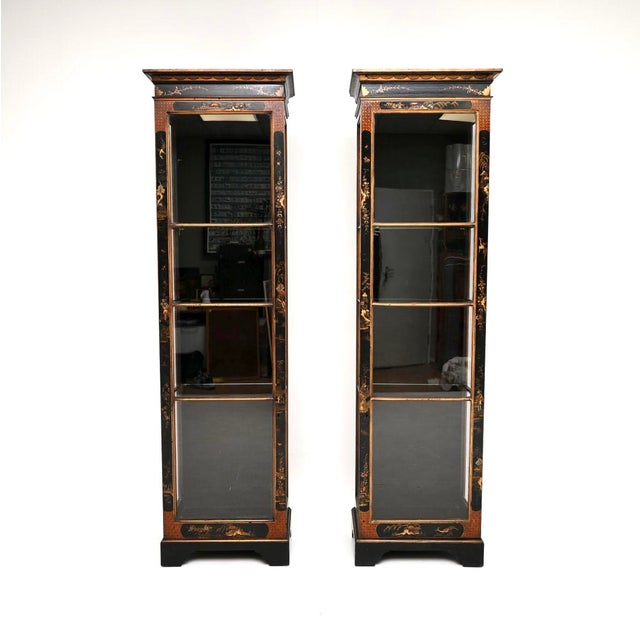 A wonderful and extremely rare pair of antique Edwardian lacquered chinoiserie display cabinets. They were made in...