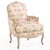 A charming pair of French Louis XV-style bergère chairs dating to circa 1940, featuring carved and painted frames with...