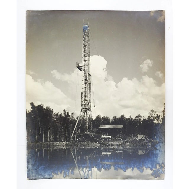 Mid century silver gelatin black and white photograph of oil well drilling rig. Unsigned. Unframed, edge wear, corner...