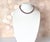 A refined necklace composed of Edison pearls displaying a rare natural dark purple color with pronounced metallic...