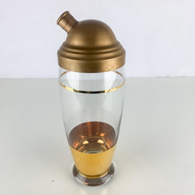 Beautiful vintage glass cocktail shaker with lid and gold band and stripe. Heavy glass. Perfect for shaking. Top is...