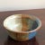 Offering a small, but dramatic mid-century modern style studio pottery bowl with vibrant, angled glazing in tones of...