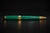A handsome ballpoint pen crafted from genuine malachite, distinguished by its rich emerald-green color and mesmerizing...