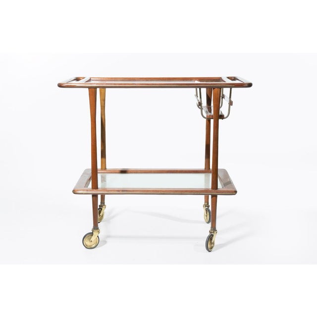 A refined and highly collectible mid-century modern bar cart designed by Cesare Lacca and produced by Cassina in Italy...