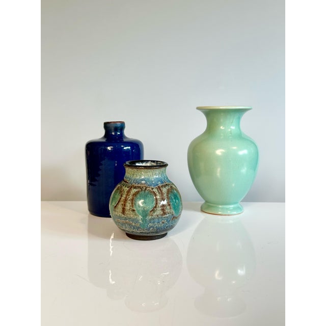 An exquisite studio-crafted ceramic vase from Denmark, made in the 1960s. The piece features a sophisticated, multicolored...