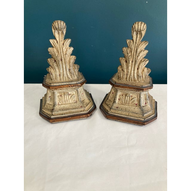 A sculptural pair of vintage ceramic bookends featuring a neoclassical acanthus leaf motif atop stepped hexagonal bases...