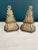A sculptural pair of vintage ceramic bookends featuring a neoclassical acanthus leaf motif atop stepped hexagonal bases...