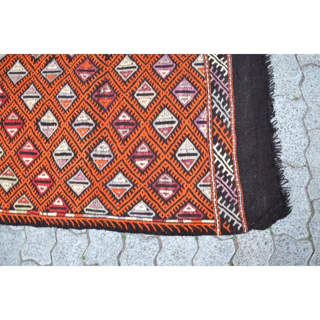 This is a vintage Turkish Anatolian kilim rug from the 1960s. The piece was hand-woven.