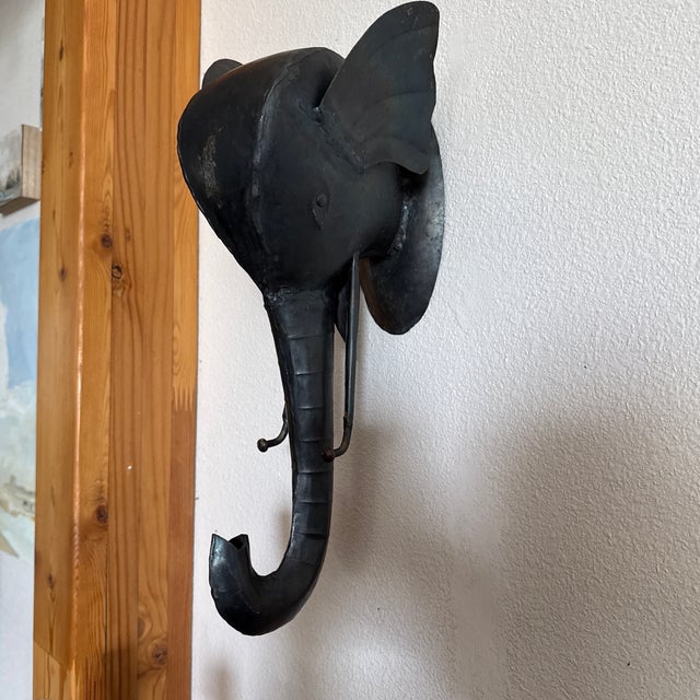 Very playful fun elephant hook - 18” long- Sculpted out of iron. You can hang things on its tusks and its trunk.