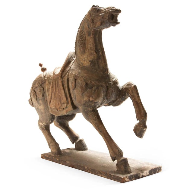 Sizable hand carved polychrome Chinese horse sculpture with detailed decoration.