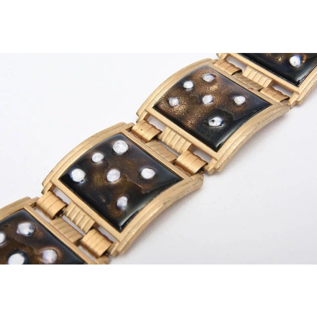 This is part of Chairish’s Costume Jewelry assortment. White enamel dots overlay the brown enamel in this vintage cuff...