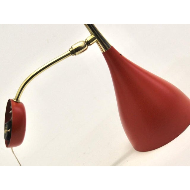 Details, elegance, and quality are exceptional in this stunning wall lamp designed by louis kalff. The original red...