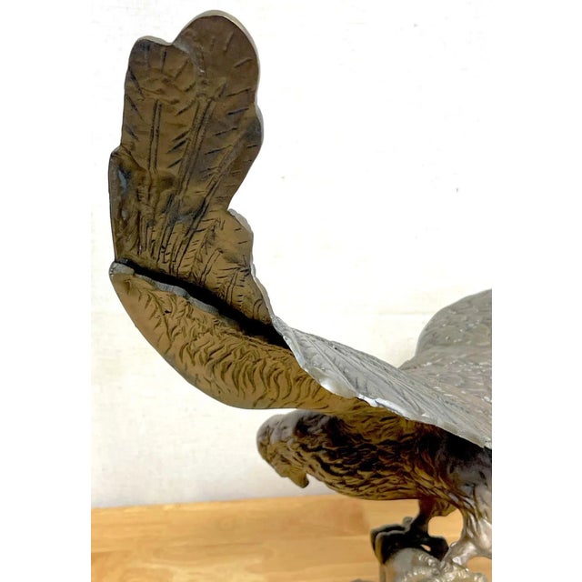 Vintage patinated bronze sculpture 'American Bald Eagle Upon Landing' USA, Circa 1960s Of large scale, realistically cast...
