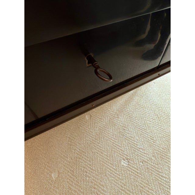 Made from dark hardwood with a beautiful gold metallic top, this console table also features two drawers for maximum...