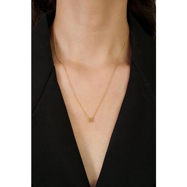 This pendant necklace features a 0.42 carat oval-cut yellow diamond, set in 18K yellow gold. The diamond measures...