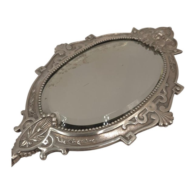 A rare and highly ornate antique Continental solid silver hand mirror, featuring a highly sought-after double-sided...