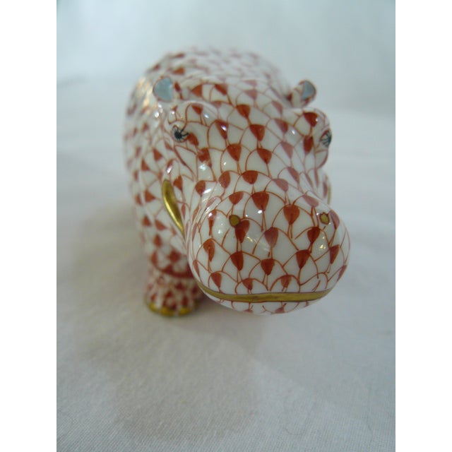 This Herend Hippo is painted in Vieux Herend (VH), the Red Fishnet design with gold accents and the palest blue ears. This...
