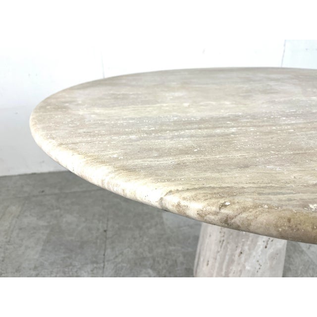 Timeless and beautiful travertine dining table very much in the style of Angelo Mangiarotti's tables. Beautiful conical...