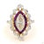 This cocktail ring centers on a 1.02-carat diamond in an elongated marquise cut. It is set with diamond and ruby accents...