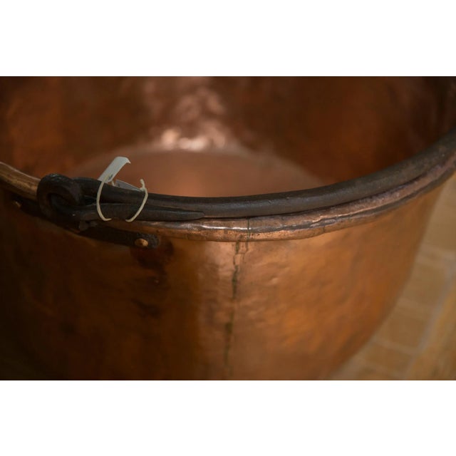 :: Large antique hammered copper kettle with blacksmithed handle, most commonly used to make apple butter, likely from the...
