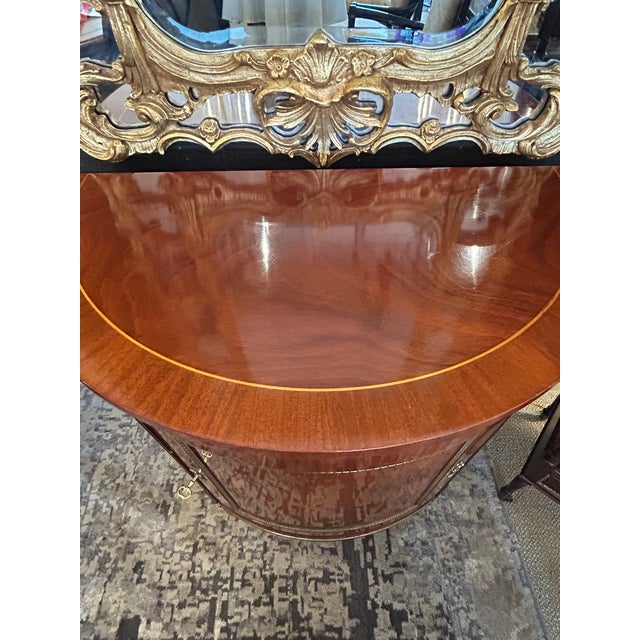 Supremely elegant glossy mahogany cabinet credenza by Kindel having demilune shape and storage inside. Ormulu decoration...