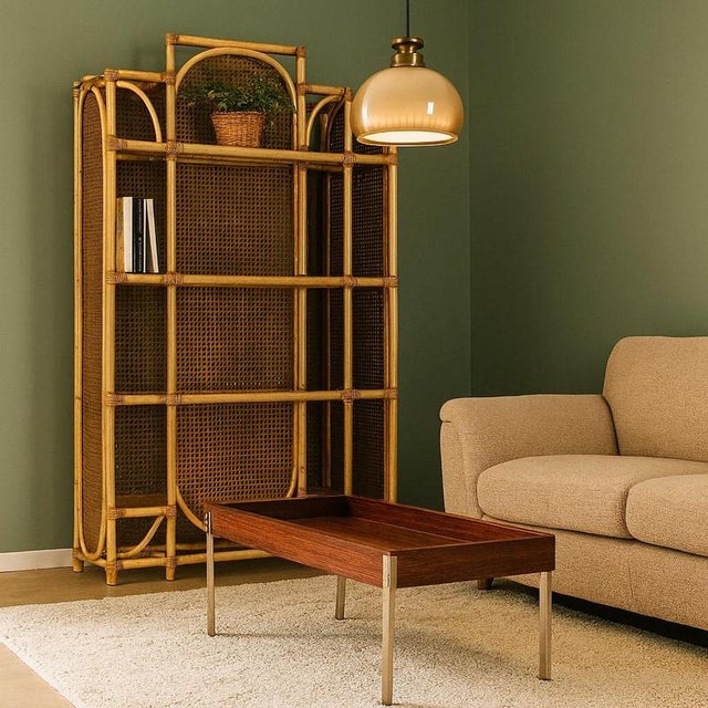 Vintage coffee table of Italian manufacture from the 1900s in exotic wood veneer and metal legs. This piece is attributed...