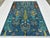This hand-knotted Afghan pictorial rug arranges borderless rows of cypress, willow, and flowering trees in burgundy, teal,...