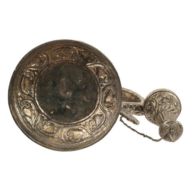 An antique Sino-Tibetan ceremonial ritual ewer in low graded silver. The body is decorated with repousse dragon...