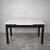 A stylish mid-century modern extending dining table, combining a crisp white Formica top with a contrasting dark stained...