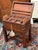 Design Plus Gallery presents an Antique Lap Desk in the Campaign Style. The desk is a portable, fold-out wooden writing...