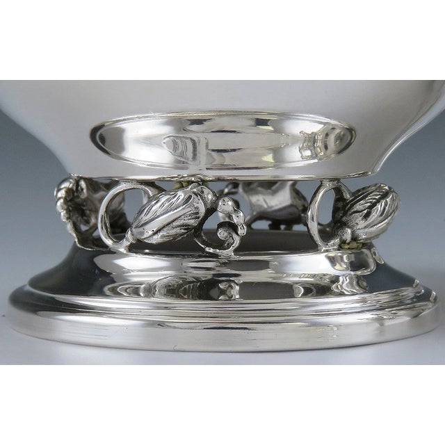 Presented is a postwar sterling silver creamer and sugar bowl made by Revere Silversmiths. This set is done in a...