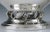Presented is a postwar sterling silver creamer and sugar bowl made by Revere Silversmiths. This set is done in a...