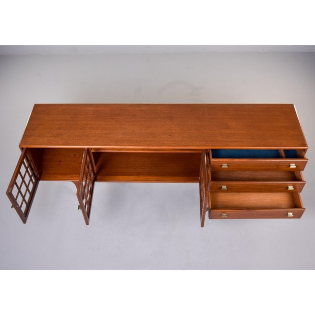 This mid-century teak sideboard by Younger is a study in British modernist design, blending architectural interest with...