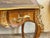 Large flat desk with curved sides, decorated with rosewood veneer within frames, it opens with three drawers in the frieze...