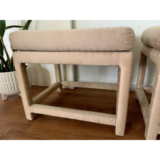 A pair of 2980’s parson style stools. Original upholstery completely envelopes the pair. It that has a subtle sheen....