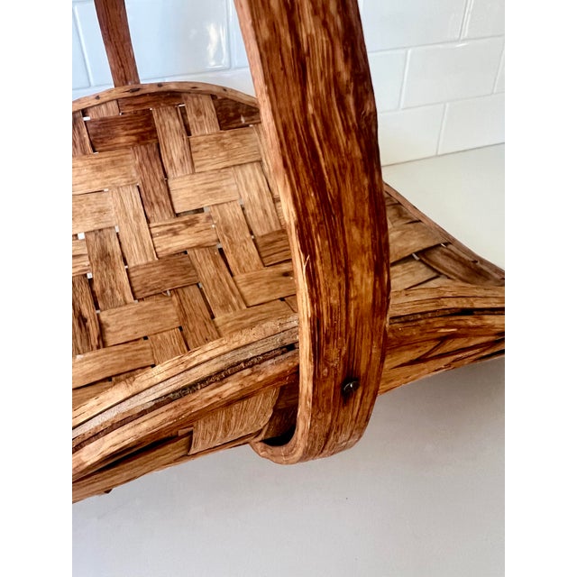 This handwoven splint oak basket, commonly known as an egg basket or gathering basket, has a strong and sturdy handle and...