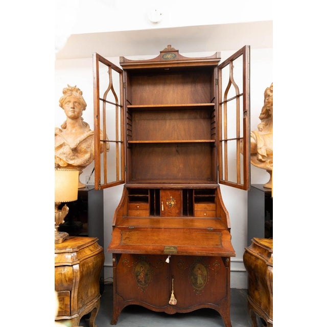 This is a lovely Edwardian walnut Secretary, the top having two glazed doors within Gothic mullions. The bottom section...