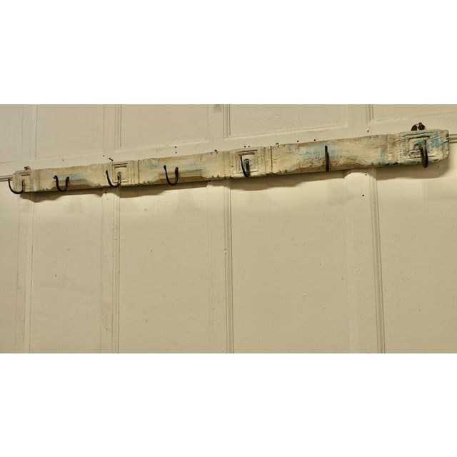 19th Century folk art long wooden 7 peg coat rack. Plain and simple, a Folk Art hand sculptured rack with Blacksmith made...