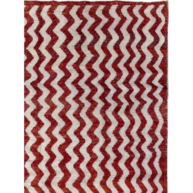 This mid-20th-century Turkish Anatolian accent rug presents a bold allover pattern of alternating crimson and ivory zigzag...