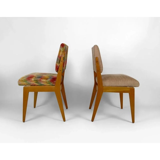 Pretty pair of mismatched vintage chairs: one has a gray / taupe / mottled beige fabric, and the other a multicolored...