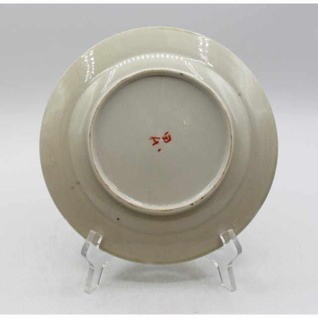 Later 19th century "Nabeshima" enamelled celadon porcelain plate, Japan. Signed. Elegantly wispy decoration featuing a...