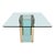 A vintage glass and brass dining table designed by the Pace Collection, featuring a central glass pedestal base held...