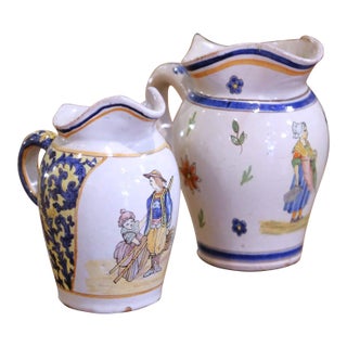 Pair of 19th Century French Quimper Faience Jugs With Breton Figures and Floral For Sale