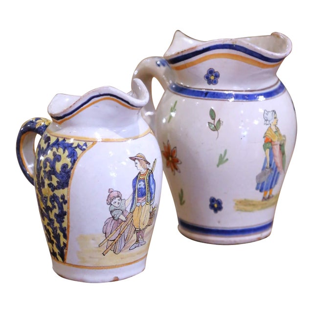 Pair of 19th Century French Quimper Faience Jugs With Breton Figures and Floral For Sale